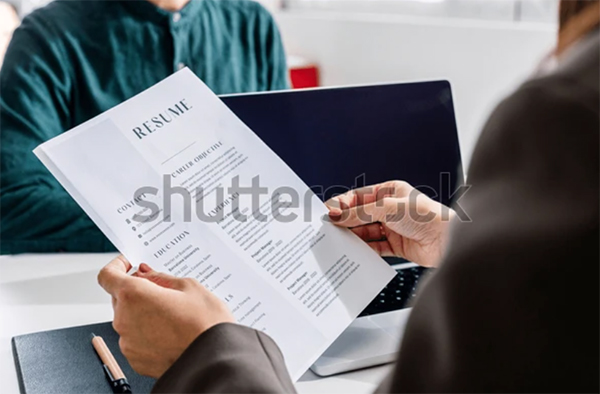 Hands of Recruiter Holding Resume